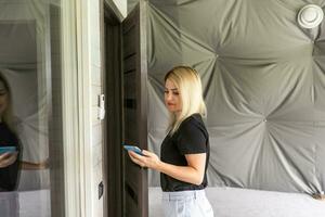 retrato de mujer joven hermosa que usa su teléfono móvil en casa. foto