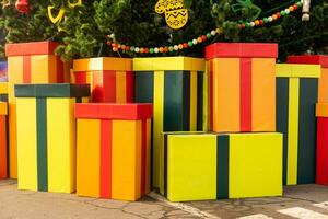 Large gift boxes with bows in the town square. Christmas street decor photo