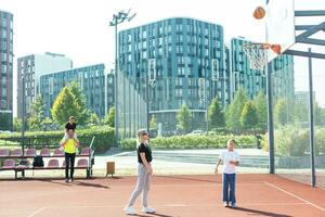 the family plays basketball on the court photo