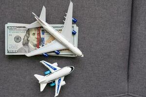 Flatlay picture of toy airplane, fake money photo