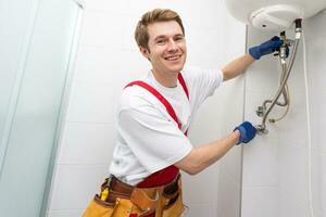 Professional engineer doing a boiler inspection at home photo