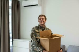 military man holding a box photo