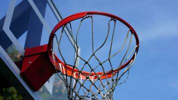 The basketball hoop view with the blue sky as background photo