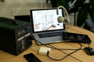 Portable power station charging devices on table in living room photo