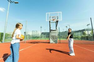 children schoolchildren playing a match about basketball against the background photo