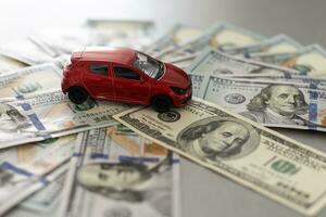 Toy car, key and money over white. Rent, buy or insurance car concept photo