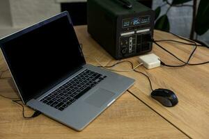 Portable power station charging devices on table in living room photo