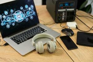 the laptop with the headset on the table at home photo