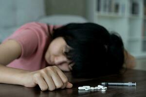 asian woman use pills overdose, stressed, sad, drug abuser, drug addict, sick, unhealthy, unhappy, suicide, depressed or hopeless, Anti drug, drug addict, life and family problems, unmotivated photo