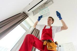 technician service checking and repairing air conditioner indoors photo