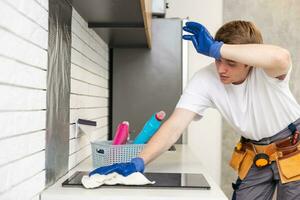 Young man is doing some cleaning work in the house photo