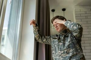 Portrait of middle aged sad, desperate military man looking thoughtful at camera during therapy session. Disabled soldier suffering from depression psychological trauma. PTSD concept. Horizontal shot photo