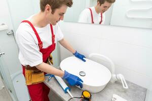 plumber service. wash basin installation photo