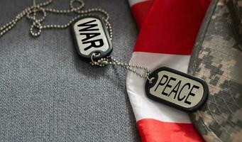 army blank, dog tag with text war peace on the khaki texture background. military concept photo