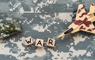 The word war in block letter laying on the floor next to dog tags photo