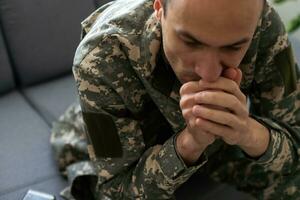 Soldier In Uniform Suffering From Stress photo