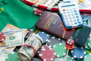 Online poker concept. Smartphone and poker chips on a green background. Poker online banner. Copy space. Vignette. Place for text. Gambling. Background. photo