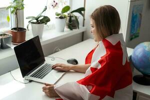 beautiful smiling woman covered in canadian flag looking at camera isolated on white photo