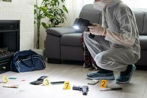 Forensics researcher photographing a blood at a murder scene photo