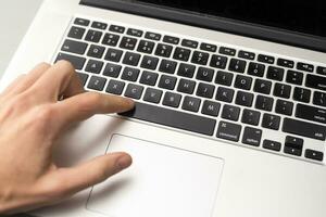 Finger pushing the button of keyboard photo