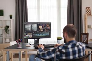 Content creator with walking disability in wheelchair working on one of his project. Young invalid film maker doing his business online, using high technology, sitting in his apartment, working remotely in special conditions. photo