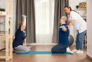 Therapist helping old people to recover after a medical intervention. Home assistance, physiotherapy, healthy lifestyle for senior old person, training and recovery with professional physiotherapist photo