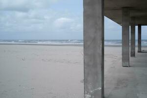 partes de hormigón edificio a el playa de el mar ai generativo foto