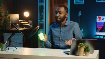BIPOC tech content creator filming technology review of mini led lights, unboxing and presenting informations to audience. Internet star showing filming equipment to subscribers photo