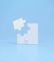 Connecting puzzle pieces on blue background. Idea, solution, strategy concept, business. photo