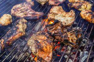 tasty grilled different meat on a grill at a party photo