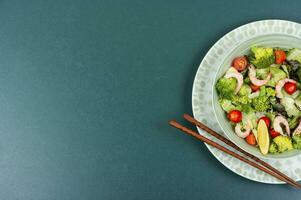 Salad with broccoli and shrimp, Asian food. photo