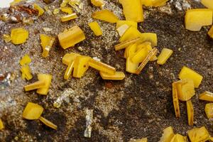 Macro mineral stone yellow Wulfenite on a white background photo