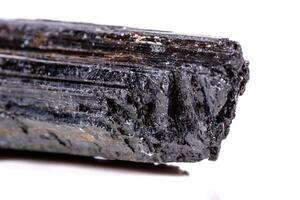 macro mineral stone sherle, schorl, black tourmaline on white background photo