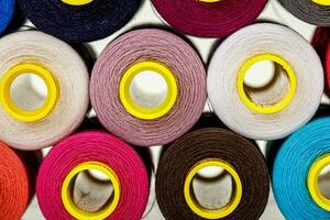 set of multi-colored spools of thread for sewing photo