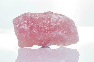 macro mineral stone rose quartz on a white background photo