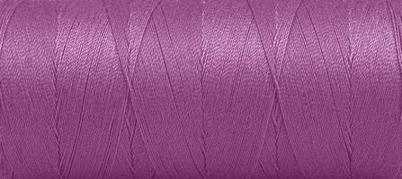 Texture of threads in a spool of purple color on a white background photo