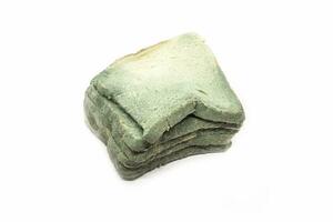 Food waste concept. Fungal bread isolated on white background. Selective focus photo