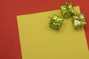 Gift boxes on yellow and red background with copy space for text photo