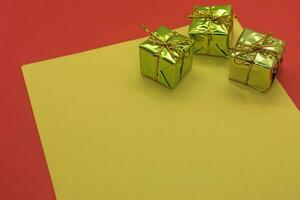 Christmas gift boxes on a yellow and red background. Copy space. photo