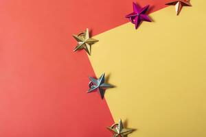 Christmas star on red and yellow background with copy space, top view photo