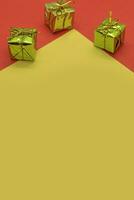 Christmas background with gift boxes on red and yellow background. Top view. photo