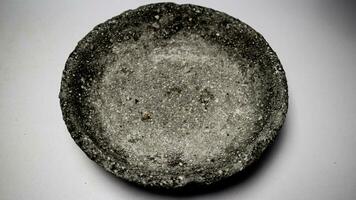 Granite mortar and pestle isolated on a white background. photo