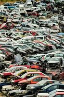 a lot of cars are piled up in a lot photo