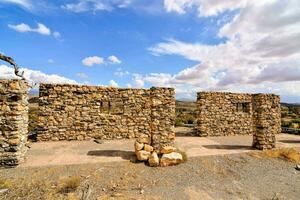 the ruins of the old adobe house in the desert photo
