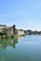 the river is clear with buildings on the banks photo