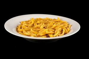 a bowl of pasta on a black background photo