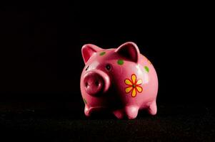 a pink piggy bank with a flower design on it photo