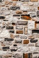 a stone wall with many different colors and textures photo