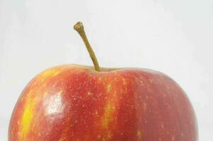 un manzana es mostrado en un blanco antecedentes foto