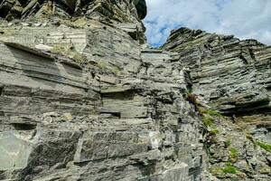 the rock face of the mountain is very steep photo